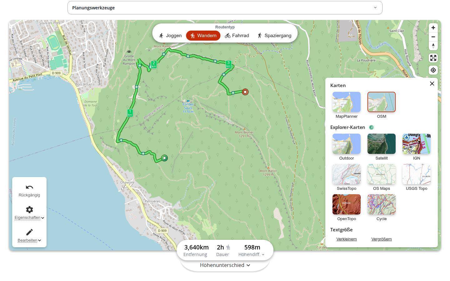 MapPlanner-Routenplaner am Computer mit geöffnetem Kartenmenü: Vorschaubilder für MapPlanner und OSM, dazu Outdoor, Satellit, IGN, SwissTopo, OS Maps, USGS Topo, OpenTopo und Cycle aus dem Explorer-Abo sowie die Einstellung der Textgröße